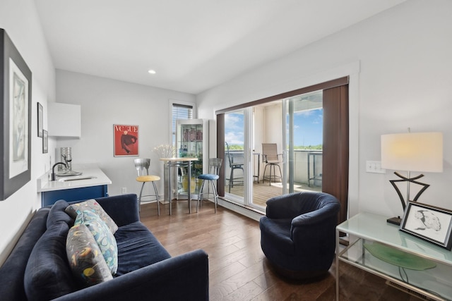 living area with recessed lighting, hardwood / wood-style floors, and baseboards