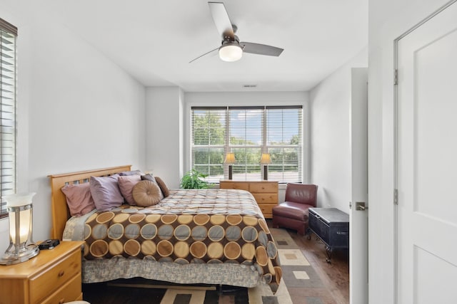 bedroom featuring wood finished floors, ceiling fan, and visible vents