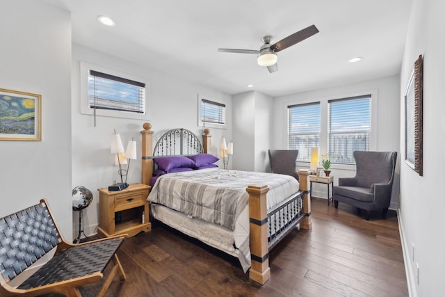 bedroom with dark wood-type flooring, baseboards, recessed lighting, and multiple windows