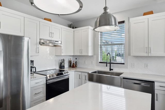 kitchen featuring a sink, stainless steel appliances, light countertops, and under cabinet range hood