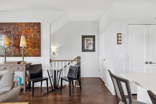 dining space with dark wood-style floors and vaulted ceiling