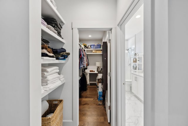 walk in closet with marble finish floor