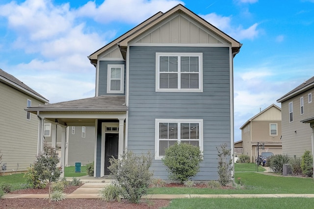 view of front of home featuring a porch, a front lawn, central AC, and board and batten siding