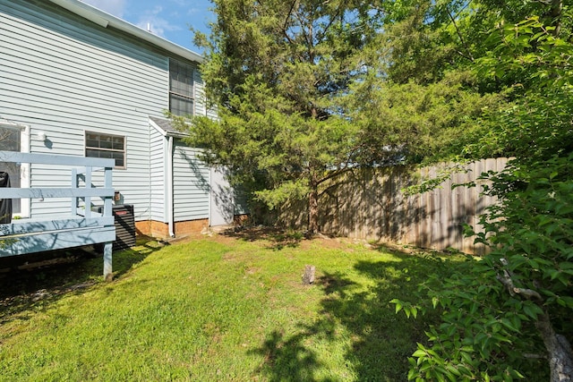 view of yard with a deck and fence