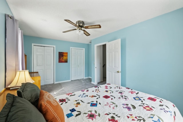 bedroom with carpet floors, a ceiling fan, baseboards, and multiple closets