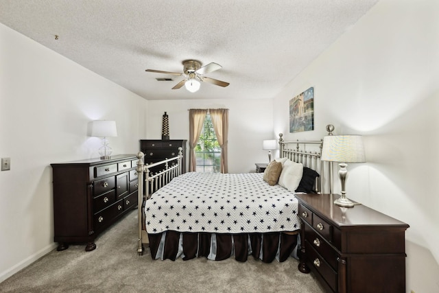 bedroom featuring ceiling fan, light carpet, a textured ceiling, baseboards, and visible vents