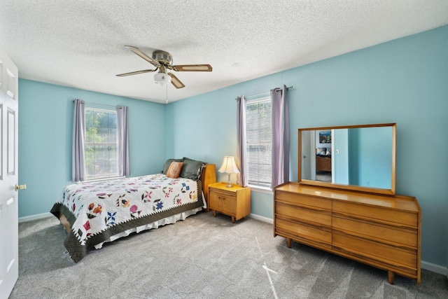 bedroom with carpet floors, a ceiling fan, and baseboards