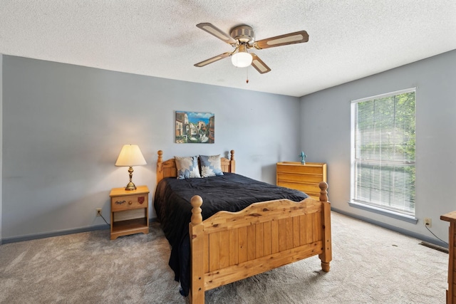 bedroom featuring carpet flooring, a ceiling fan, a textured ceiling, and baseboards