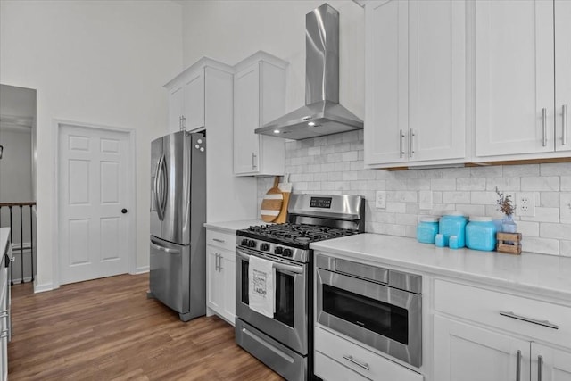 7327 Hunting Camp Rd, Fairview, TN 37062 - kitchen with white cabinets, wall chimney range hood, light countertops, and stainless steel appliances