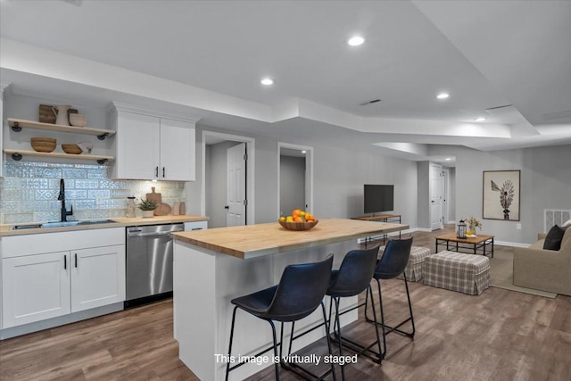 7327 Hunting Camp Rd, Fairview, TN 37062 - kitchen featuring a sink, wood counters, open floor plan, stainless steel dishwasher, and a raised ceiling