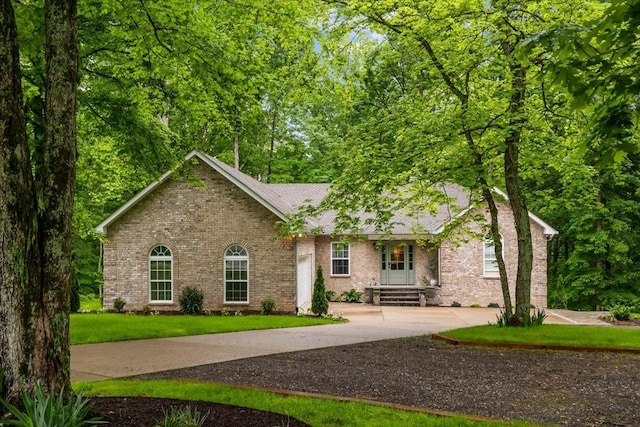 7327 Hunting Camp Rd, Fairview, TN 37062 - single story home with a front lawn, concrete driveway, and brick siding