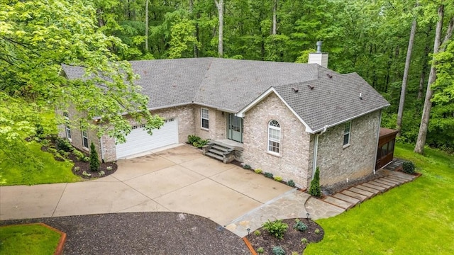 7327 Hunting Camp Rd, Fairview, TN 37062 - view of front of home featuring a garage, brick siding, a chimney, and a front yard