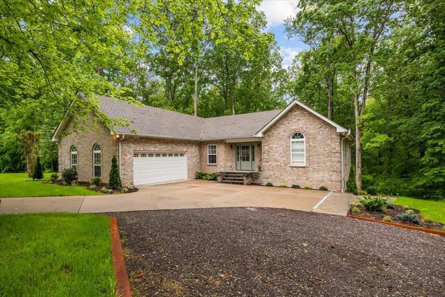 7327 Hunting Camp Rd, Fairview, TN 37062 - ranch-style home with an attached garage, concrete driveway, a front yard, brick siding, and roof with shingles