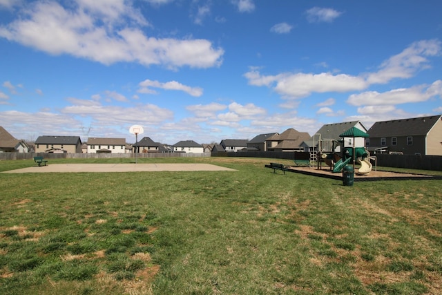 view of yard with fence, playground community, and a residential view
