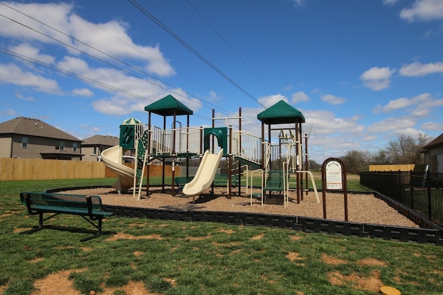 community play area featuring fence and a yard