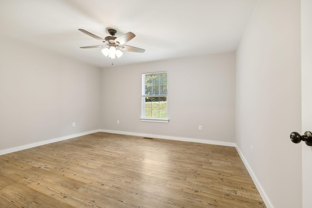 unfurnished room with baseboards, wood finished floors, and ceiling fan