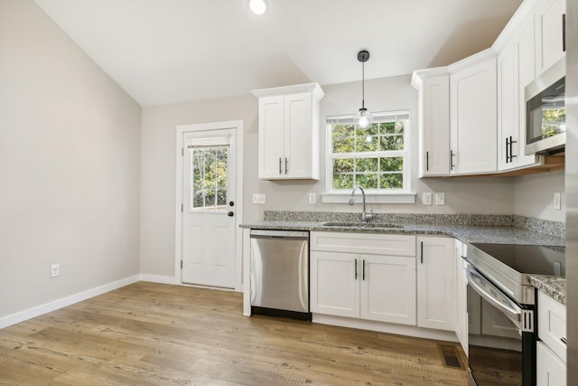 kitchen with a sink, decorative light fixtures, baseboards, white cabinets, and appliances with stainless steel finishes