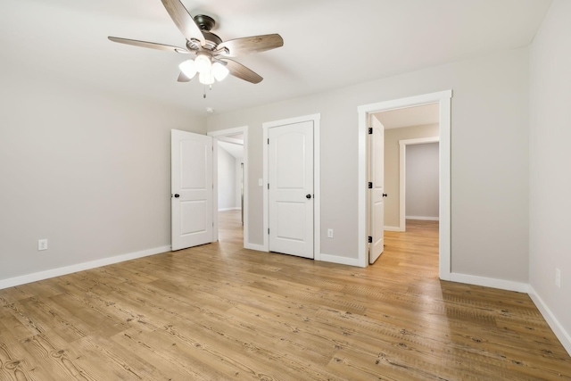 unfurnished bedroom featuring baseboards, a ceiling fan, and light wood-style flooring