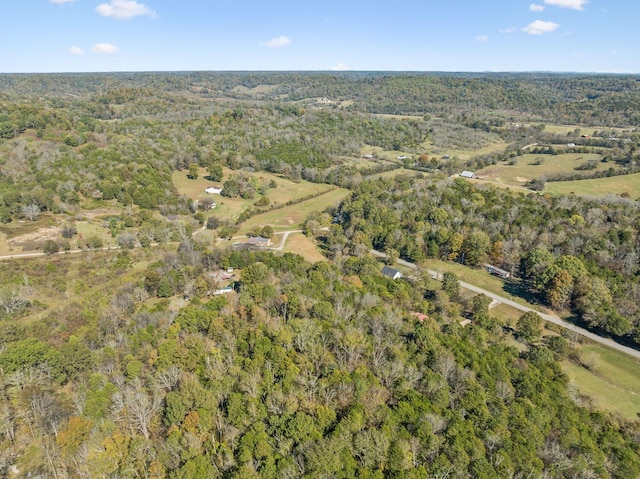 drone / aerial view with a wooded view
