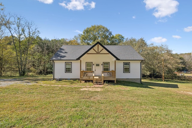 rear view of house featuring roof with shingles, a yard, and crawl space