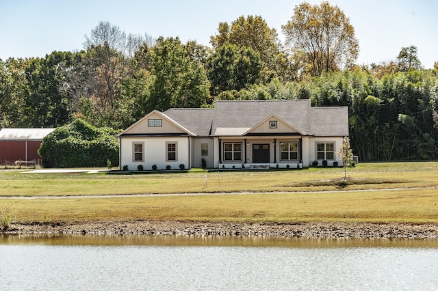 view of front of home featuring a water view and a front lawn