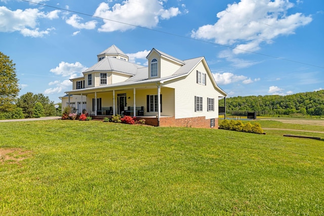 exterior space featuring a porch and a lawn