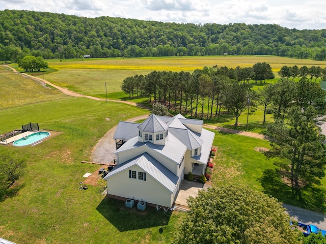 bird's eye view with a wooded view and a rural view