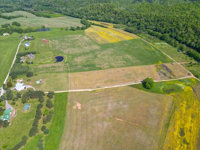 drone / aerial view featuring a rural view and a wooded view