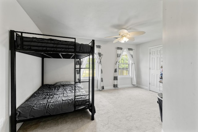 carpeted bedroom featuring a ceiling fan and baseboards