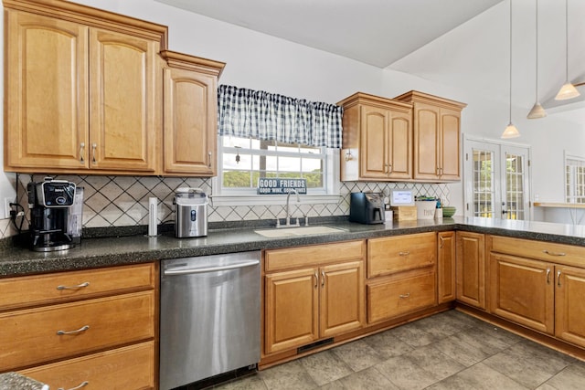 kitchen with tasteful backsplash, hanging light fixtures, dark countertops, dishwasher, and a sink