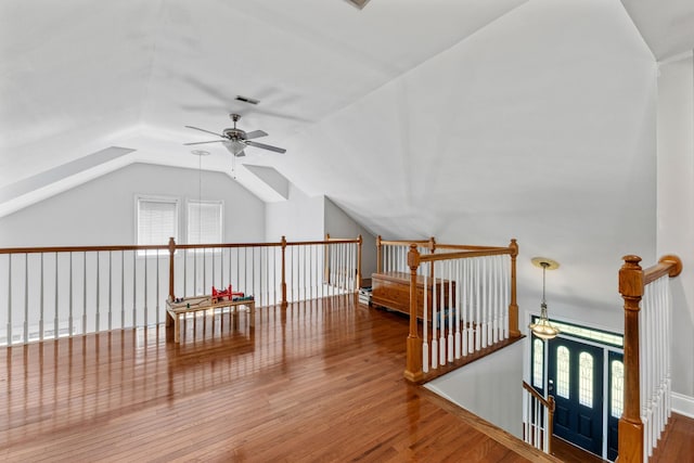 additional living space with a ceiling fan, visible vents, lofted ceiling, and wood finished floors