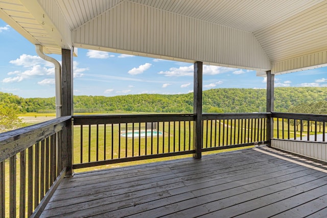 wooden terrace with a wooded view