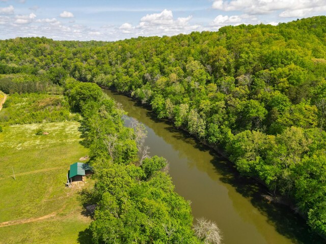 birds eye view of property featuring a view of trees