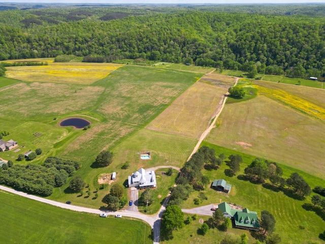 drone / aerial view with a wooded view