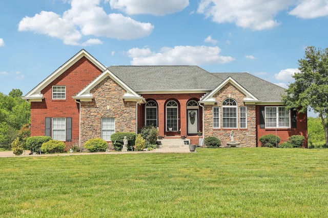 4025 Moore Hollow Rd, Woodlawn, TN 37191 - view of front of property with a front yard, stone siding, and roof with shingles