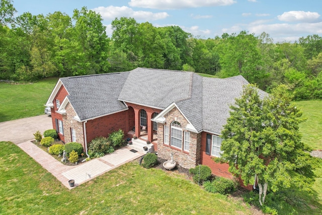 4025 Moore Hollow Rd, Woodlawn, TN 37191 - ranch-style home featuring stone siding, brick siding, a front lawn, and roof with shingles