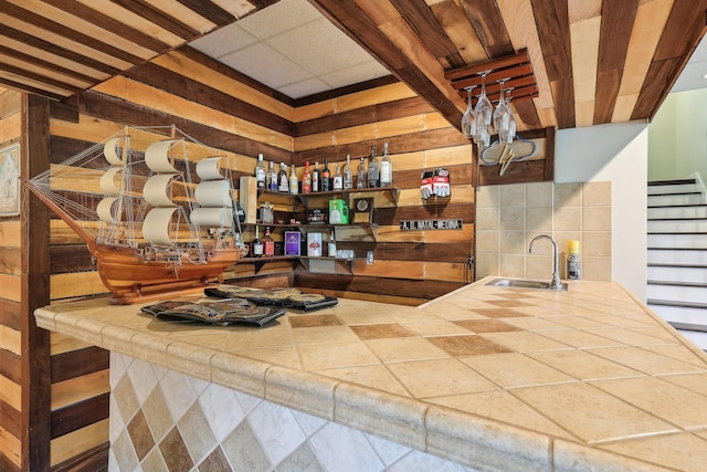 4025 Moore Hollow Rd, Woodlawn, TN 37191 - bar featuring wood walls, stairway, and a sink
