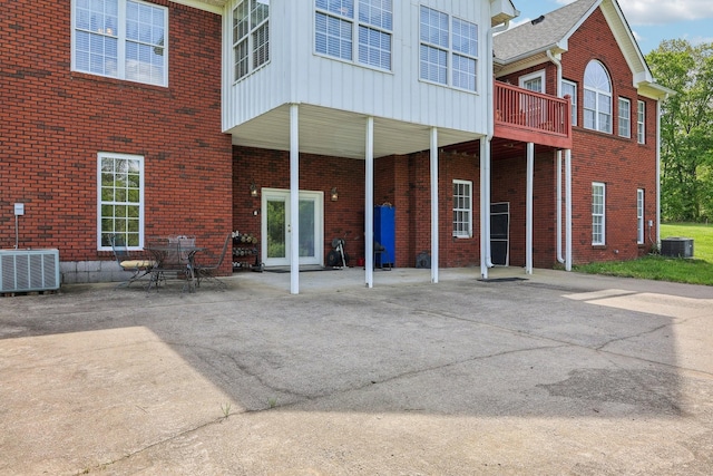 4025 Moore Hollow Rd, Woodlawn, TN 37191 - back of property featuring board and batten siding, central air condition unit, and brick siding