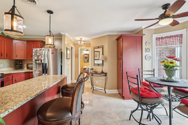 4025 Moore Hollow Rd, Woodlawn, TN 37191 - kitchen featuring a kitchen breakfast bar, a ceiling fan, stainless steel refrigerator with ice dispenser, backsplash, and pendant lighting