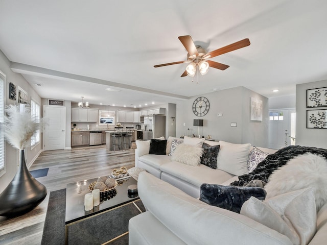 living room featuring light wood-type flooring, ceiling fan, and recessed lighting