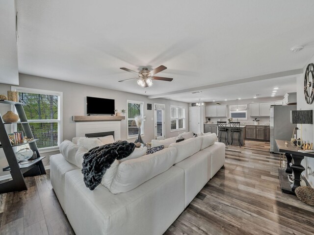 living room featuring recessed lighting, a ceiling fan, wood finished floors, and a fireplace