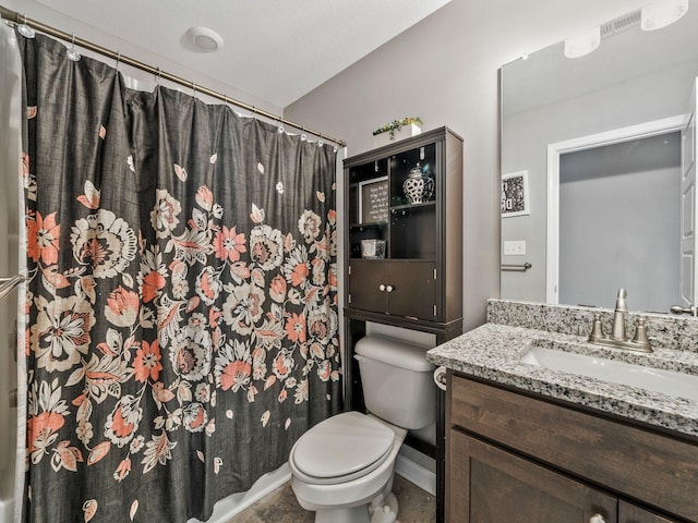 bathroom featuring vanity, toilet, curtained shower, and baseboards