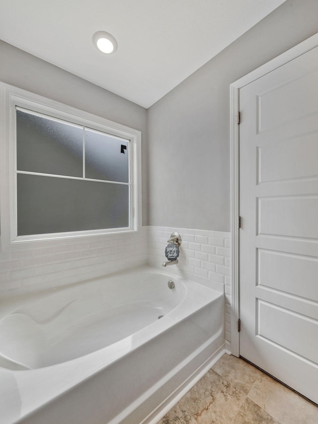 full bath with a garden tub
