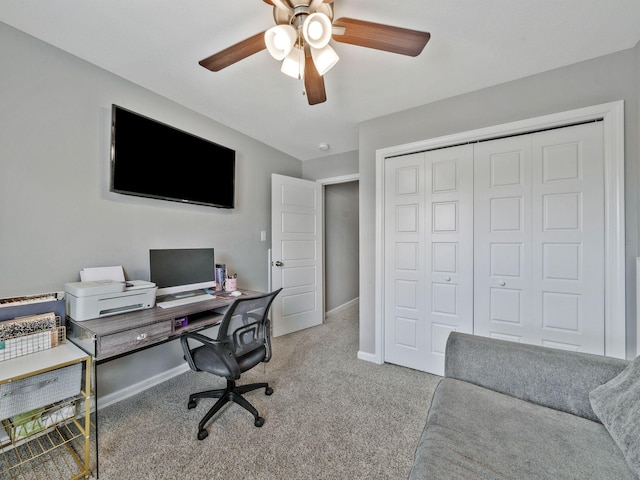 office space with carpet, ceiling fan, and baseboards