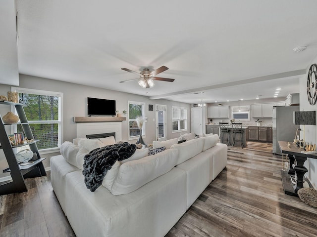 living room featuring recessed lighting, a ceiling fan, wood finished floors, and a fireplace