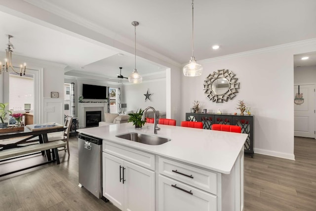 4372 Spregan Way, Smyrna, TN 37167 - kitchen featuring dark wood-style flooring, dishwasher, a glass covered fireplace, a sink, and crown molding