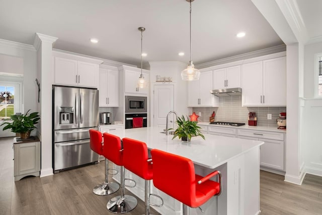 4372 Spregan Way, Smyrna, TN 37167 - kitchen featuring white cabinets, light wood-type flooring, ornamental molding, and appliances with stainless steel finishes