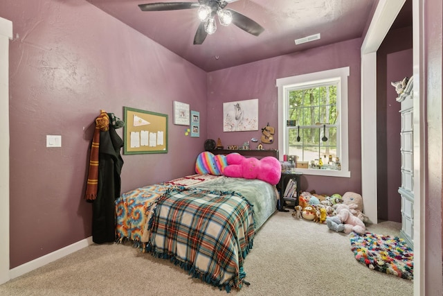 bedroom with visible vents, a ceiling fan, and carpet