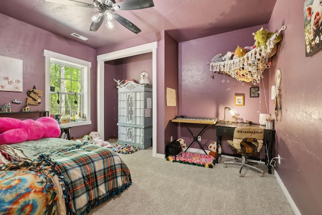 carpeted bedroom featuring baseboards, visible vents, and a ceiling fan