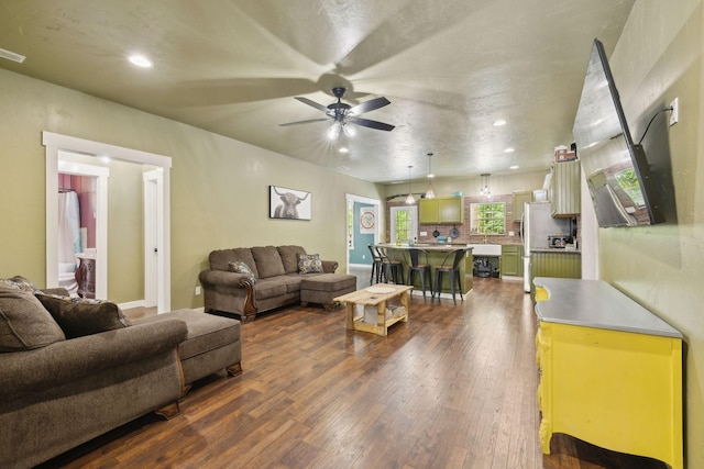 living room featuring ceiling fan, recessed lighting, and dark wood-style floors